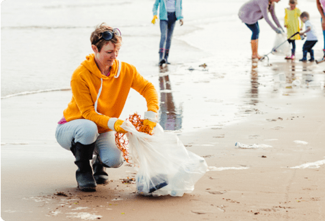 Person collecting trash from beach