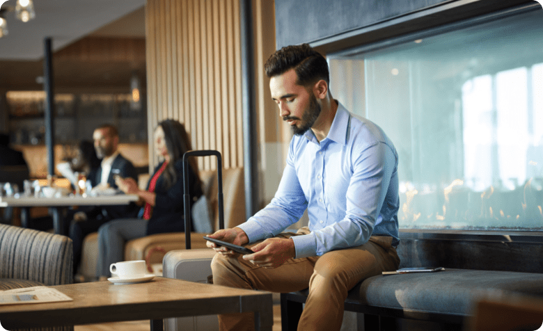 man sitting in café with phone
