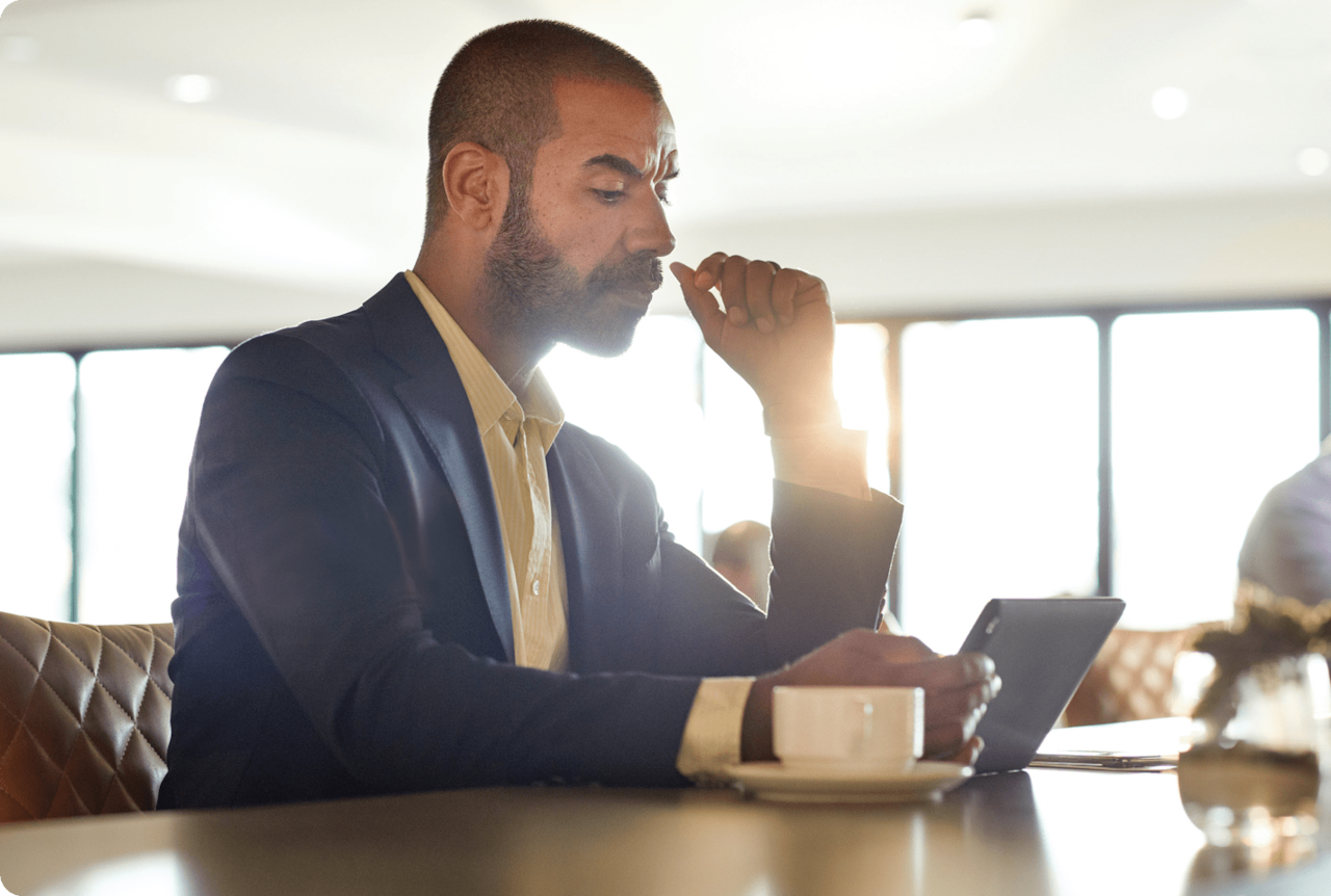 man sitting at counter with phone